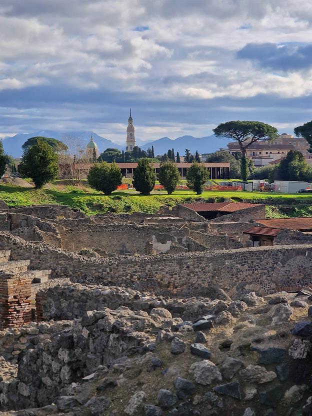 Im Hintergrund ist die "neue Altstadt" von Pompeji zu sehen. Sie liegt in der Nähe der berühmten archäologischen Stätte. Diese moderne Stadt hat sich um die antiken Ruinen herum entwickelt und bietet eine Mischung aus historischem Charme und modernem Leben.
(01.2025)