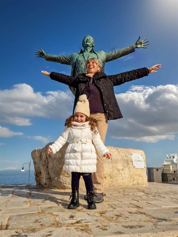 In Polignano steht eine Statue des berühmten Sängers Domenico Modugno, der mit seinem Hit „Nel blu dipinto di blu“ (auch bekannt als „Volare“) weltberühmt wurde. Die Statue zeigt ihn in einer typisch dramatischen Pose, als würde er gleich abheben und über die Adria fliegen – passend zum Liedtitel. Die Einheimischen lieben die Statue und haben ihr den Spitznamen „Mister Volare“ gegeben. Es gibt sogar eine Legende, dass die Statue nachts zum Leben erwacht, wenn der Mond über dem Meer scheint. Dann soll Domenico Modugno leise „Volare, oh oh…“ summen, während er über die engen Gassen von Polignano schlendert und den Touristen ein paar musikalische Träume schenkt.
(01.2025)